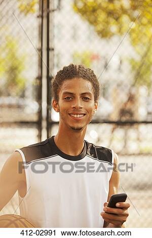 Man standing on basketball court View Large Photo Image Stock Image - Man standing on basketball court. Fotosearch
