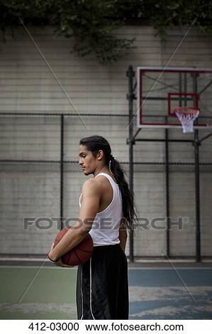 Man standing on basketball court View Large Photo Image Stock Image - Man standing on basketball court. Fotosearch