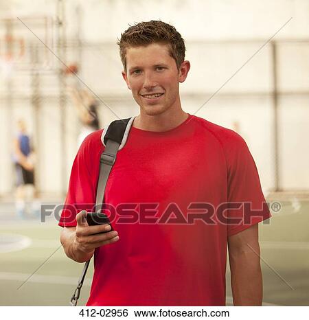 Man standing on basketball court View Large Photo Image Stock Photograph - Man standing on basketball court. Fotosearch