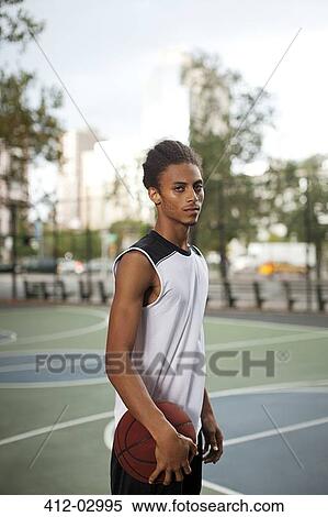 Man standing on basketball court View Large Photo Image Stock Photography - Man standing on basketball court. Fotosearch