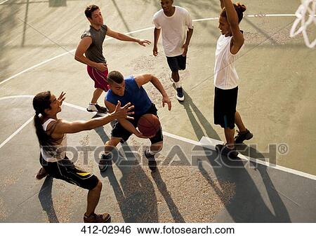 Men playing basketball on court View Large Photo Image Stock Photograph - Men playing basketball on court. Fotosearch