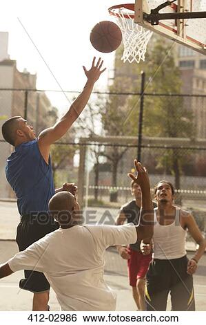 Men playing basketball on court View Large Photo Image Stock Photograph - Men playing basketball on court. Fotosearch