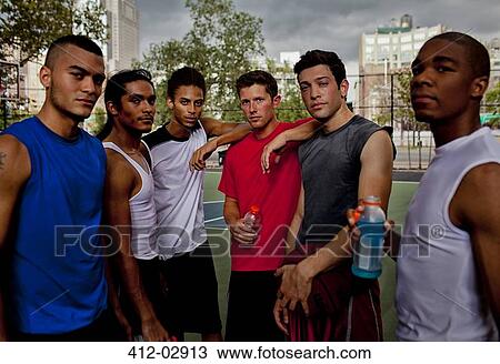 Stock Image - Men standing on basketball court. Fotosearch