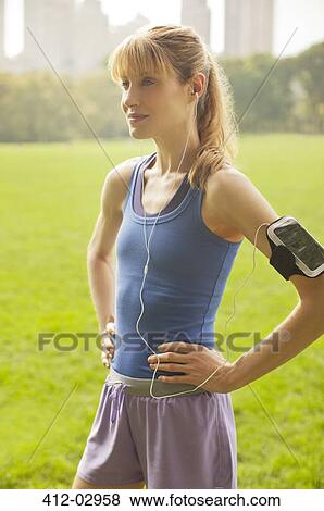 Stock Photo - Runner standing in urban park. Fotosearch