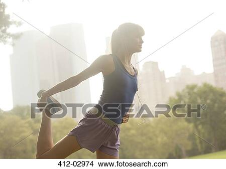 Runner stretching in urban park View Large Photo Image Picture - Runner stretching in urban park. Fotosearch