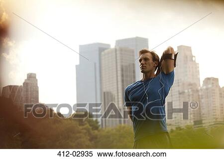 Stock Photography - Runner stretching in urban park. Fotosearch