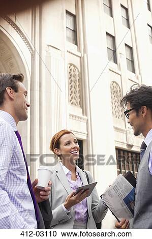 Stock Image - Business people talking on city street. Fotosearch