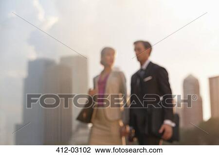 Business people walking in urban park View Large Photo Image Stock Image - Business people walking in urban park. Fotosearch