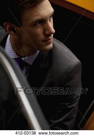 Stock Photo - Businessman climbing out of taxi. Fotosearch
