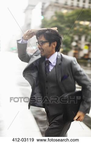 Stock Photo - Businessman crossing city street. Fotosearch