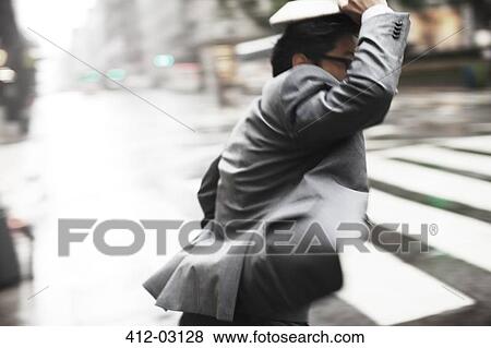 Stock Photo - Businessman crossing city street. Fotosearch
