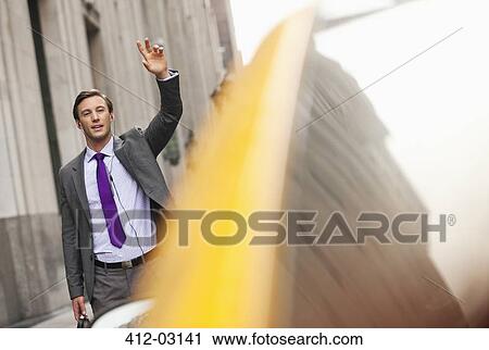 Businessman hailing taxi on city street View Large Photo Image Stock Image - Businessman hailing taxi on city street. Fotosearch