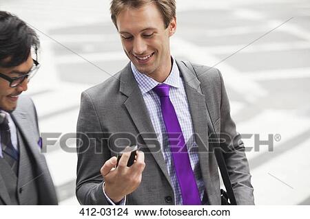 Businessmen talking on city street View Large Photo Image Picture - Businessmen talking on city street. Fotosearch