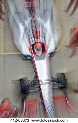 Stock Image - Blurred view of race car on track. Fotosearch