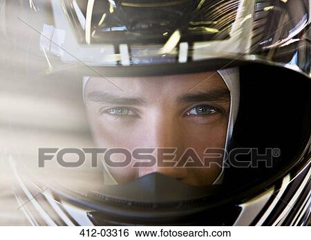 Stock Photograph - Close up of racer wearing helmet. Fotosearch