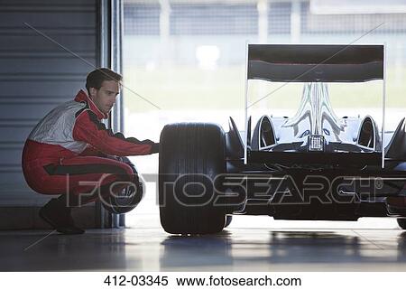 Mechanic working on race car in garage View Large Photo Image Stock Photography - Mechanic working on race car in garage. Fotosearch