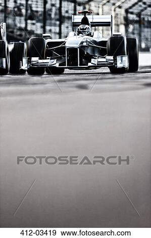 Race car driving on track View Large Photo Image Stock Photo - Race car driving on track. Fotosearch