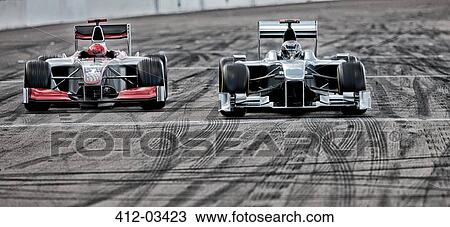 Stock Image - Race cars driving on track. Fotosearch