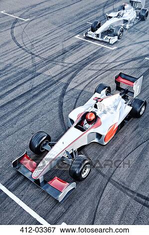 Race cars driving on track View Large Photo Image Stock Photo - Race cars driving on track. Fotosearch