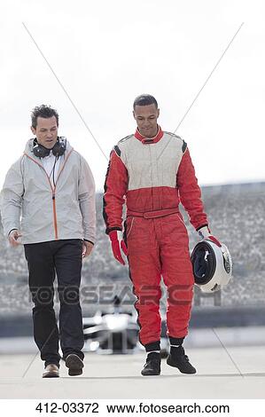 Racer and manager walking on track View Large Photo Image Stock Image - Racer and manager walking on track. Fotosearch