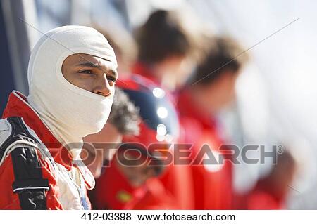 Racer and team standing on sidelines View Large Photo Image Stock Photo - Racer and team standing on sidelines. Fotosearch