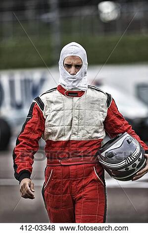 Racer carrying helmet on track View Large Photo Image Stock Photo - Racer carrying helmet on track. Fotosearch