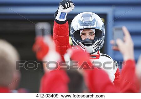 Racer cheering with team on track View Large Photo Image Stock Photo - Racer cheering with team on track. Fotosearch