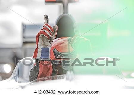 Racer gesturing in car View Large Photo Image Stock Image - Racer gesturing in car. Fotosearch