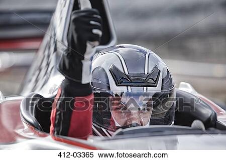 Stock Photography - Racer giving thumbs up from car on track. Fotosearch
