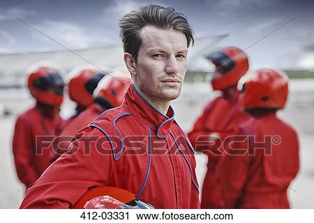 Racer holding helmet on track View Large Photo Image Stock Image - Racer holding helmet on track. Fotosearch