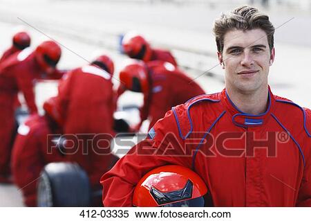 Stock Photography - Racer holding helmet on track. Fotosearch