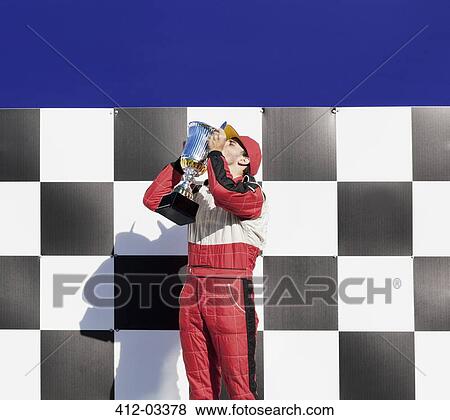 Racer kissing trophy at award ceremony View Large Photo Image Stock Photo - Racer kissing trophy at award ceremony. Fotosearch