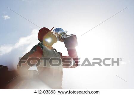 Stock Image - Racer kissing trophy on track. Fotosearch