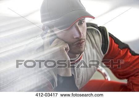 Racer talking on cell phone View Large Photo Image Stock Photo - Racer talking on cell phone. Fotosearch