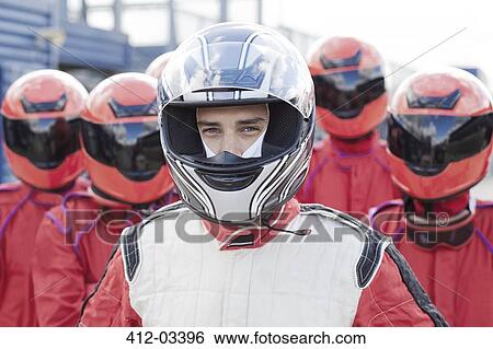 Racer with team standing outdoors View Large Photo Image Stock Photograph - Racer with team standing outdoors. Fotosearch