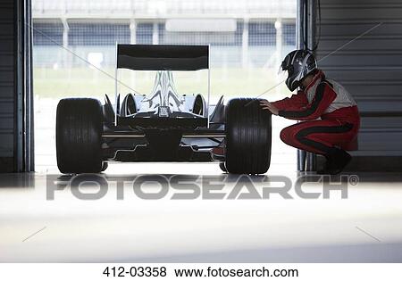 Racer working on car in garage View Large Photo Image Stock Photo - Racer working on car in garage. Fotosearch