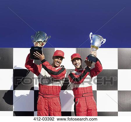 Racers holding trophies at award ceremony View Large Photo Image Stock Image - Racers holding trophies at award ceremony. Fotosearch