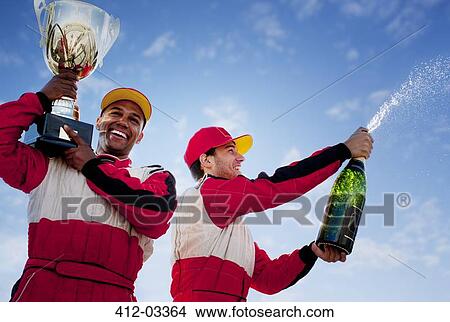 Picture - Racers holding trophy and champagne. Fotosearch
