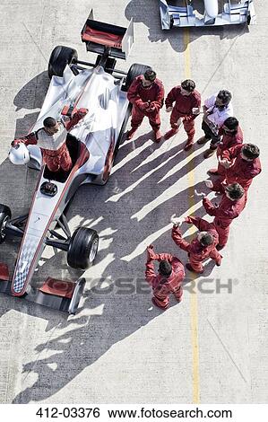 Racing team surrounding racer on track View Large Photo Image Stock Photograph - Racing team surrounding racer on track. Fotosearch