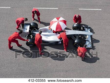 Stock Photography - Racing team working at pit stop. Fotosearch