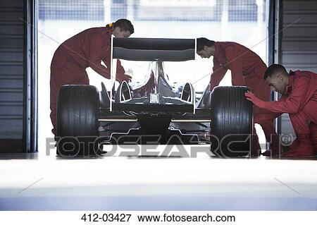 Racing team working in garage View Large Photo Image Stock Photo - Racing team working in garage. Fotosearch