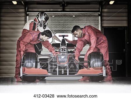 Racing team working in garage View Large Photo Image Stock Photo - Racing team working in garage. Fotosearch