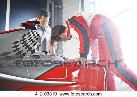 Stock Photo - Racing team working on car. Fotosearch