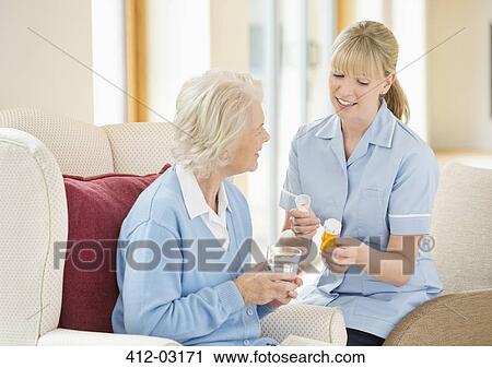 Stock Image - Caregiver talking with older woman. Fotosearch