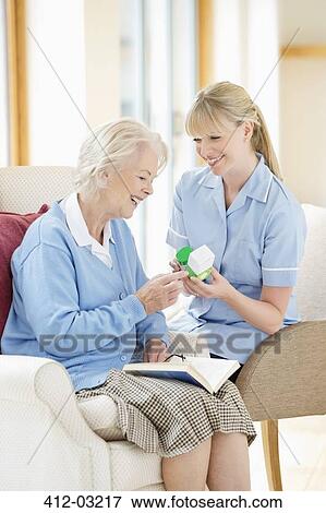 Caregiver talking with older woman View Large Photo Image Stock Photo - Caregiver talking with older woman. Fotosearch