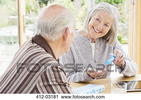 Caucasian couple organizing pills View Large Photo Image Stock Image - Caucasian couple organizing pills. Fotosearch