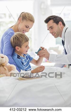 Doctor giving son asthma inhaler View Large Photo Image Stock Image - Doctor giving son asthma inhaler. Fotosearch
