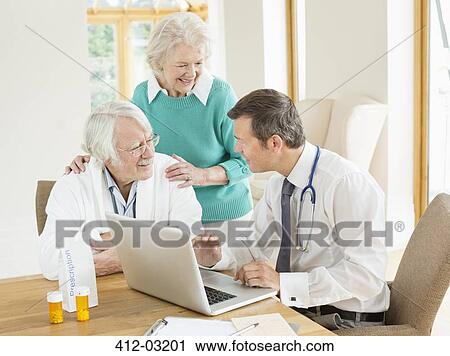 Doctor speaking with older patients at house call View Large Photo Image Stock Image - Doctor speaking with older patients at house call. Fotosearch