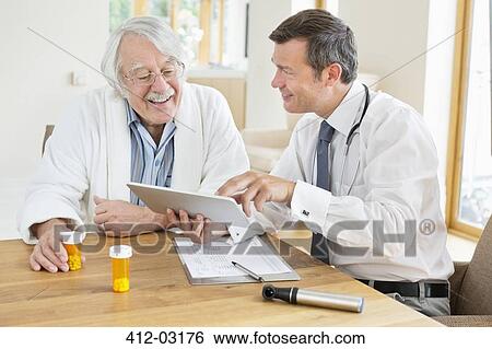 Doctor talking to older patient at house call View Large Photo Image Stock Photograph - Doctor talking to older patient at house call. Fotosearch