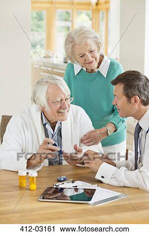 Doctor talking with older patient and wife View Large Photo Image Stock Image - Doctor talking with older patient and wife. Fotosearch